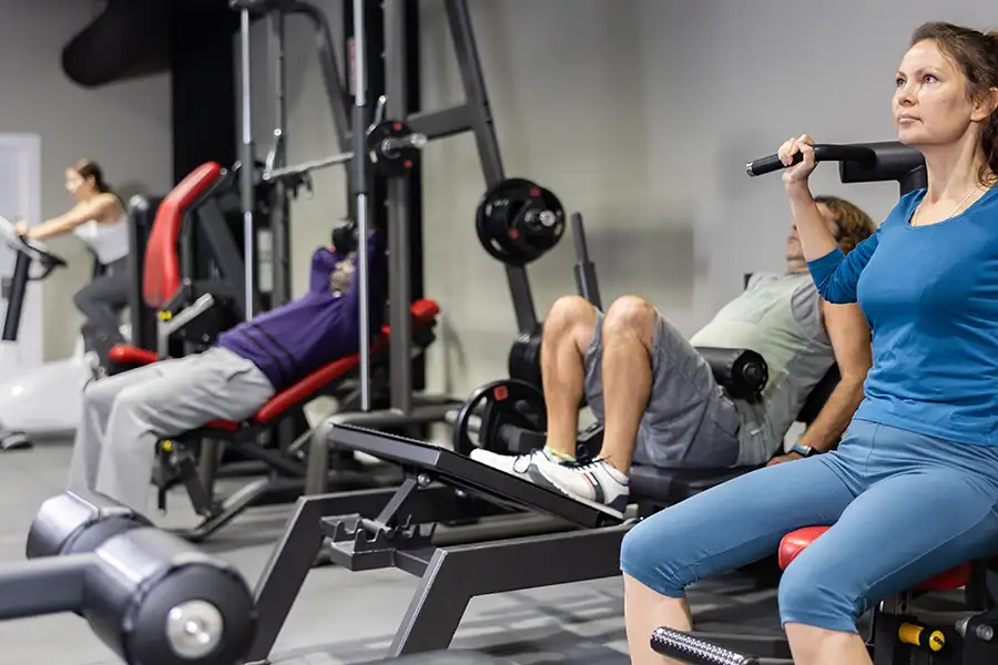 regular people working out at the gym, using variety of strength training equipment - Collinsville, IL - Bethalto, IL