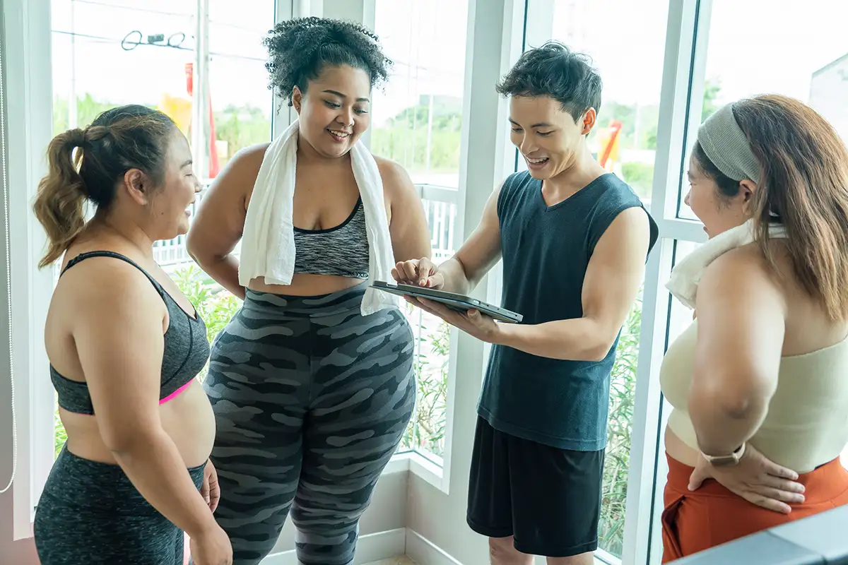 group of young women ready to work out, talking with personal trainer - Collinsville, IL - Bethalto, IL - gym membership